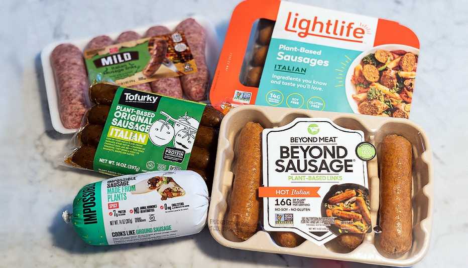 assortment of vegan sausage products beyond impossible tofurkey lightline and regular meat pork sausage