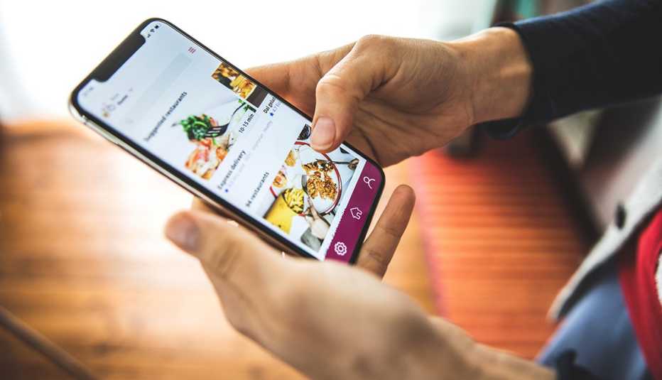 close up of a woman placing a takeout order on a food delivery smartphone app