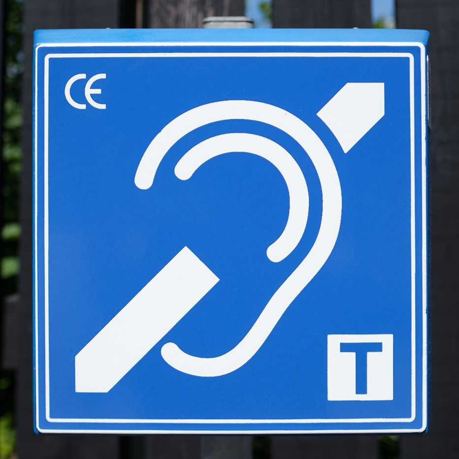 Hearing Loop Symbol. An audio induction loop to aid people with hearing aids. The "T" symbol an available telecoil compatible system. A white symbol on a blue background.