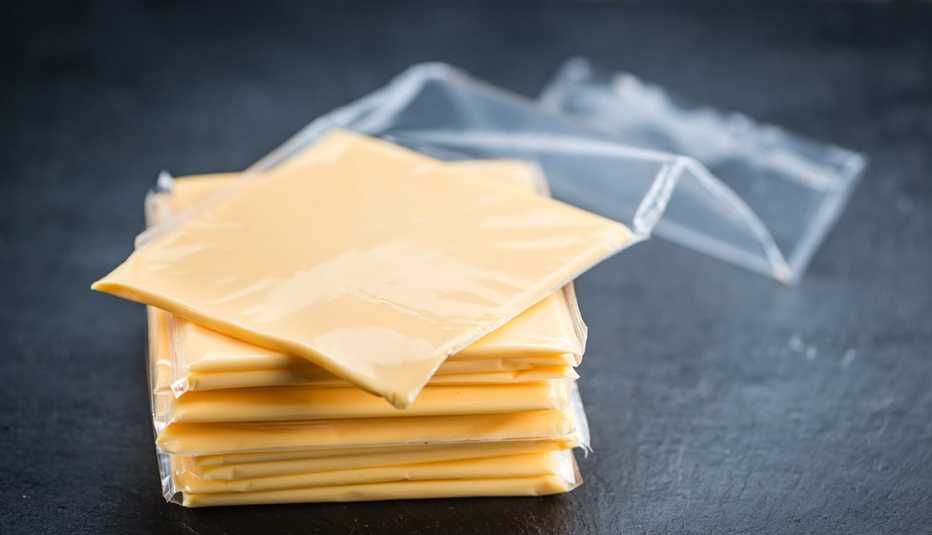 close up of wrapped Kraft Singles American cheese slices on a rustic slate slab
