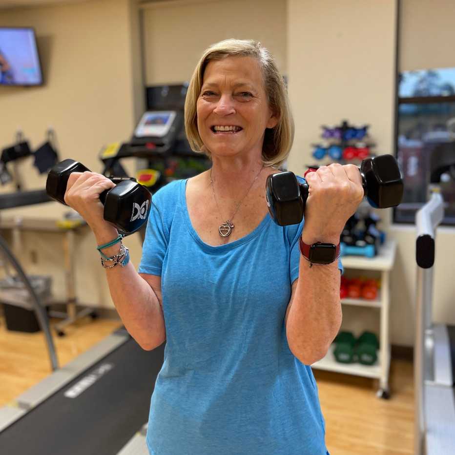 beth ramsey working out with hand weights at physical rehab