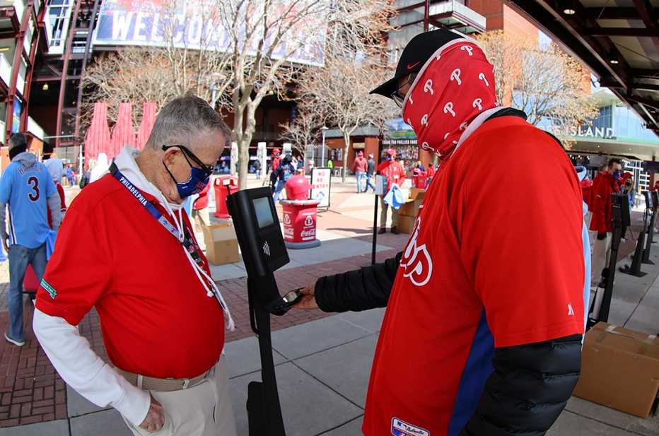 Philadelphia Phillies fans scan their phones for ticketless entry at the gate prior to the Major League Baseball game between the Philadelphia Phillies and the Atlanta Braves on April 1, 2021 at Citizens Bank Park in Philadelphia, PA.  (Photo by Rich Graessle/Icon Sportswire via Getty Images)
