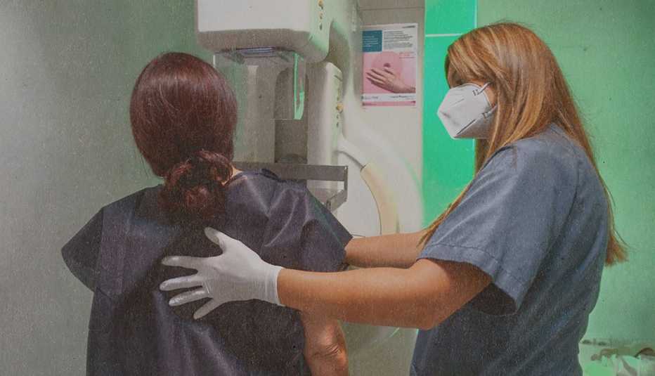 woman getting a mammogram is being helped by the technician