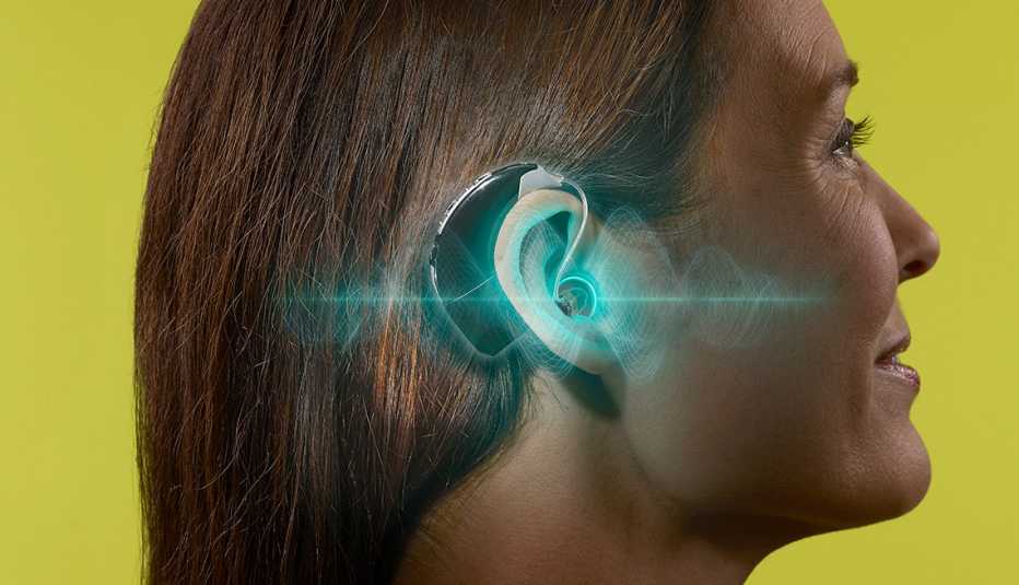 closeup of woman wearing hearing aid and the hearing aid is highlighted and glowing