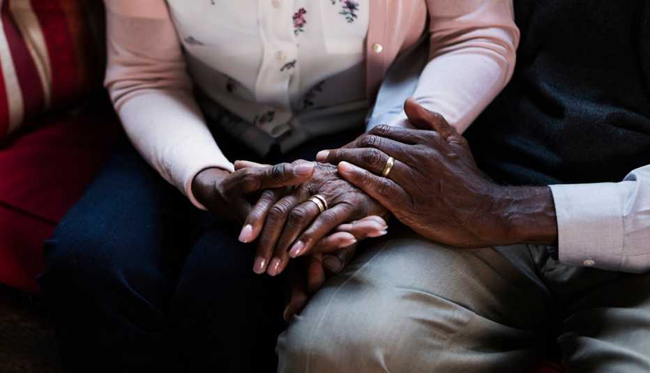 A close-up view of a couple holding each other's hands
