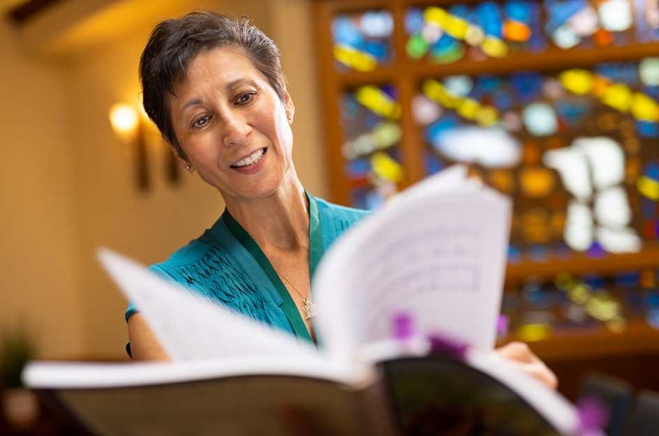 Myra Garcia in church with a music book