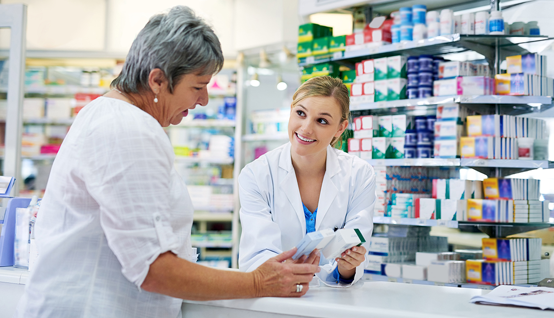 Pharmacist assisting a woman at the counter