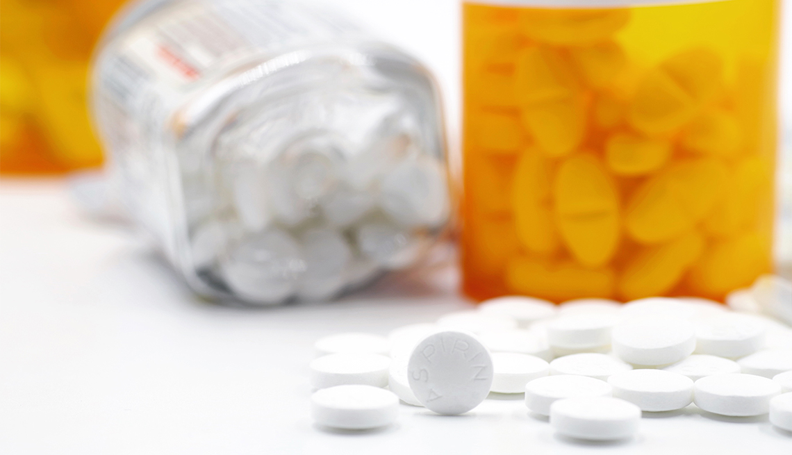 Photograph of aspirin pills and pill bottles on white background