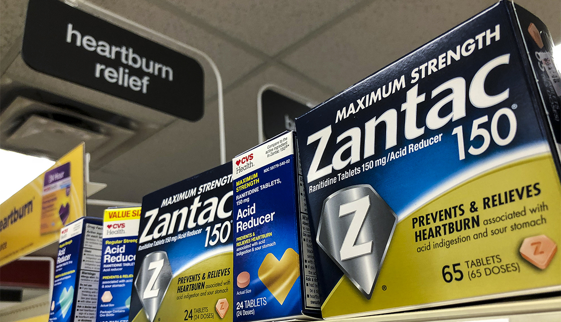 Packages of Zantac, a popular medication which decreases stomach acid production and prevents heartburn, sit on a shelf at a drugstore 