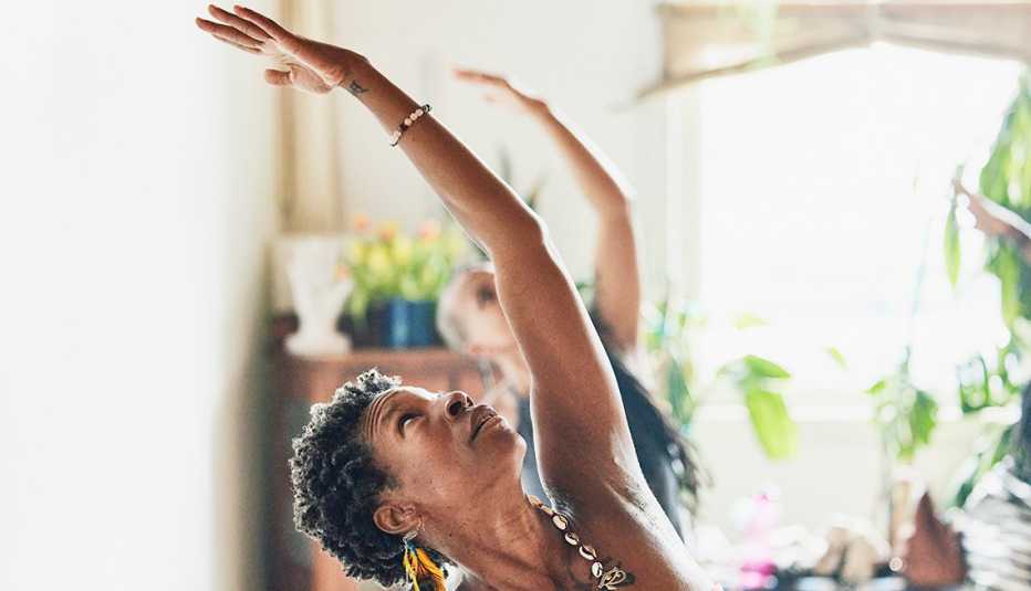shot of woman in reverse warrior pose during class in yoga studio 