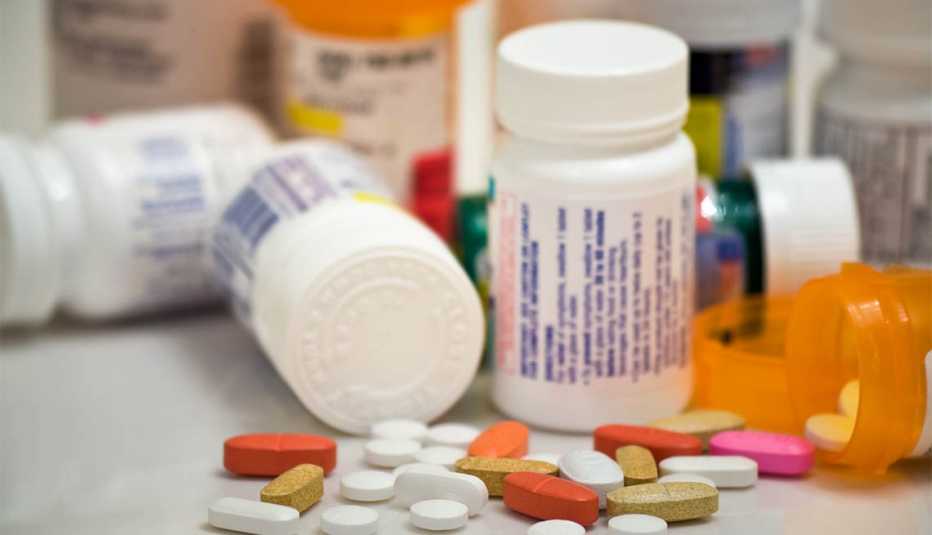 Prescription drugs on a table with many medication bottles