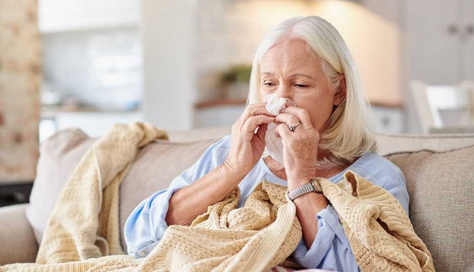 woman with a sinus infection blowing her nose