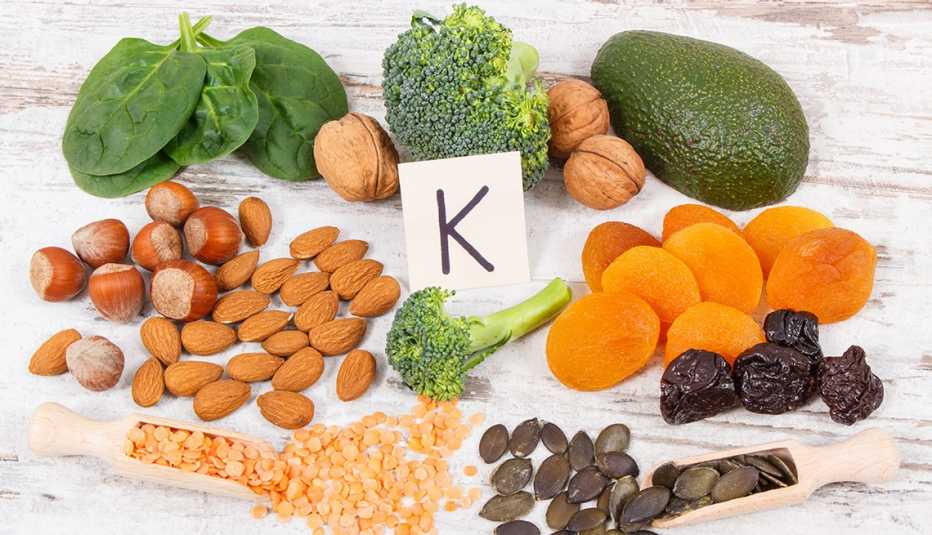 Fresh fruits and vegetables containing vitamin K, with the letter K