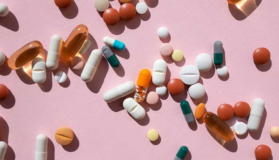pills and tablets on pink background