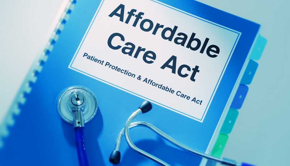 Close-up of a medical stethoscope laying on top of an Affordable Care Act Manual Book.