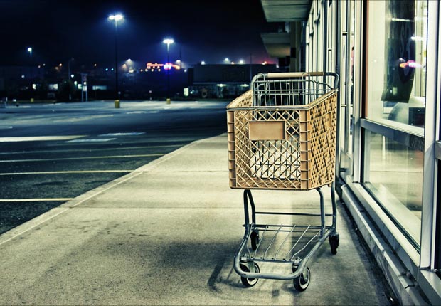 Empty shopping cart on sidewalk, Stop shopping and start saving