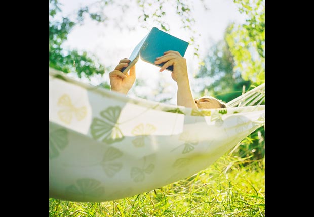 Man reading book in hammock, Trim your TV time