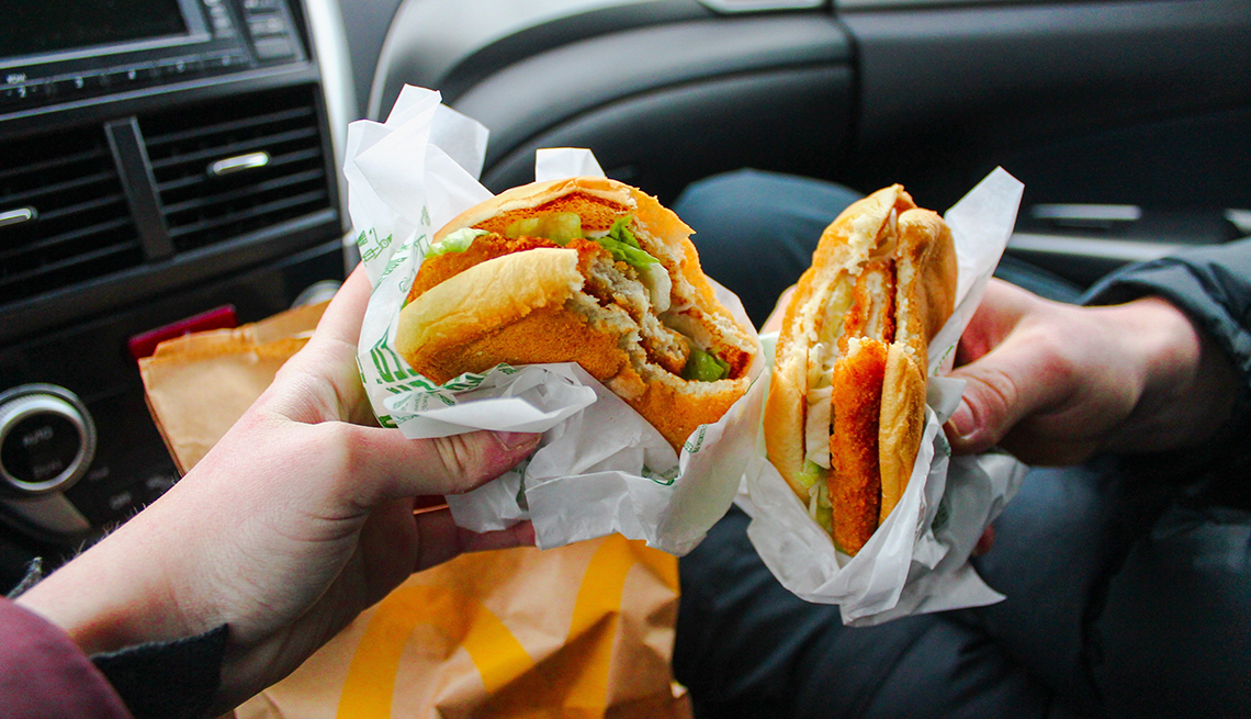 Hands holding fast food sandwhich