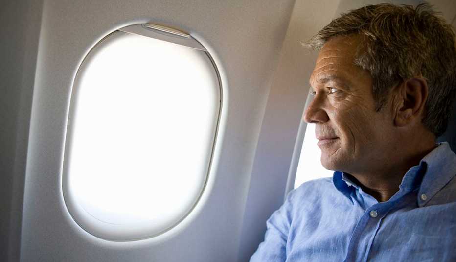 Man staring out of an airplane