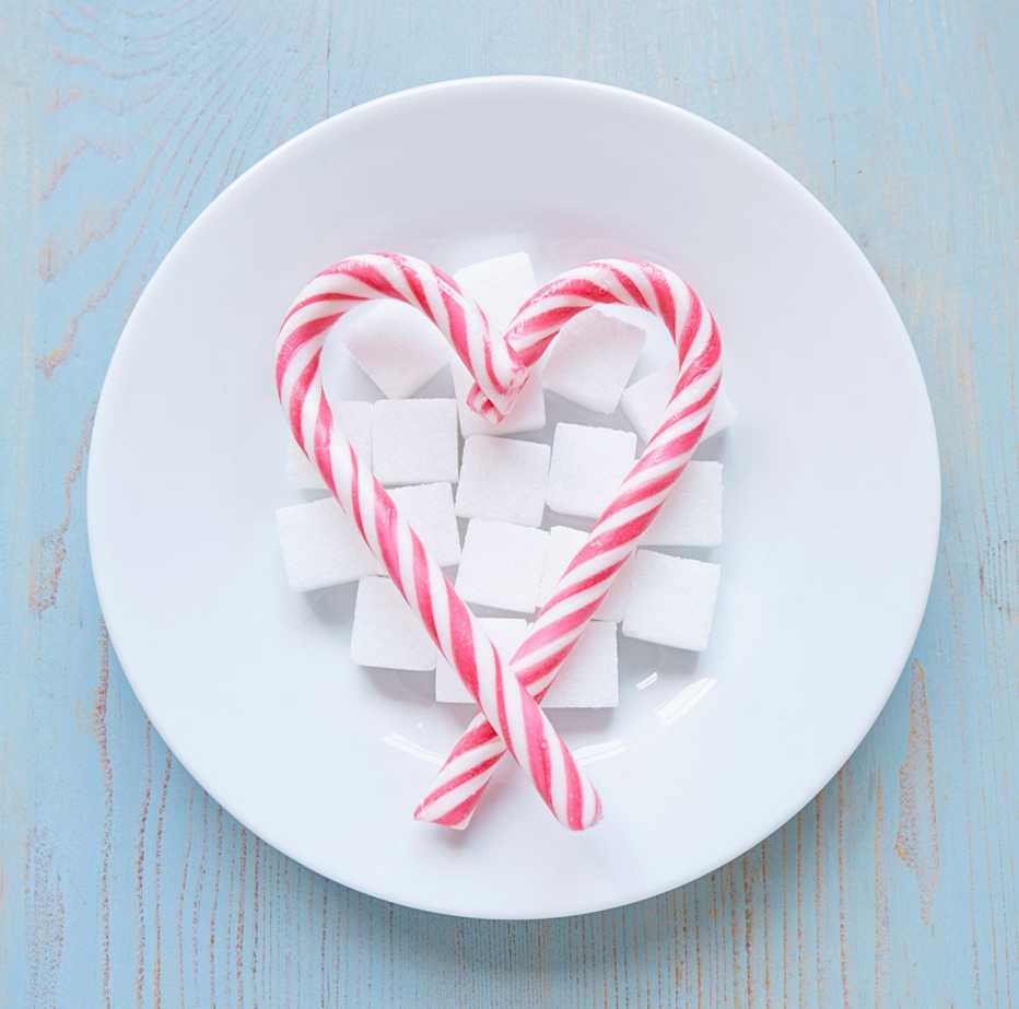 High angle view of sugar sticks on plate, heart shape