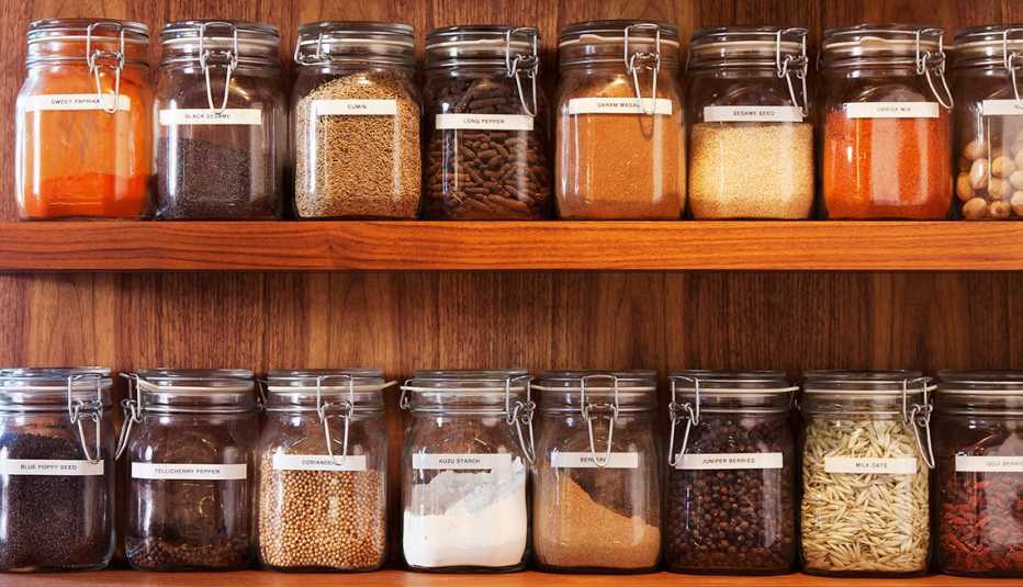 Wooden shelves of spices in glass jars