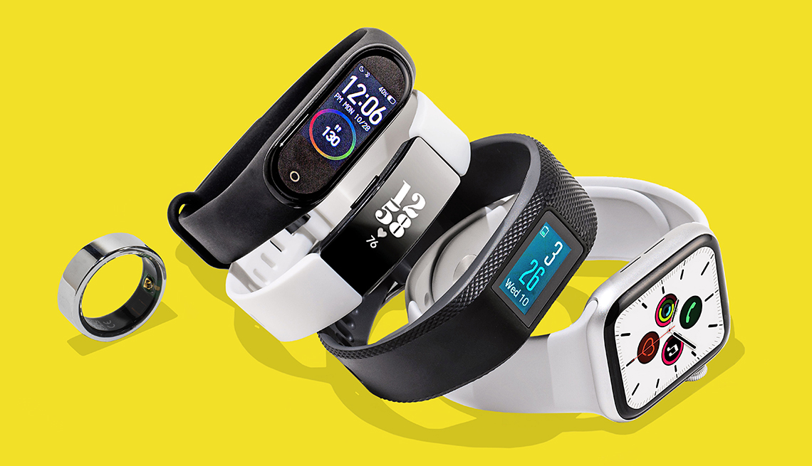 five types of fitness trackers are pictured. from left to right are the oura ring, mi smart band 4, fitbit inspire hr, garmin vivosport, and apple watch