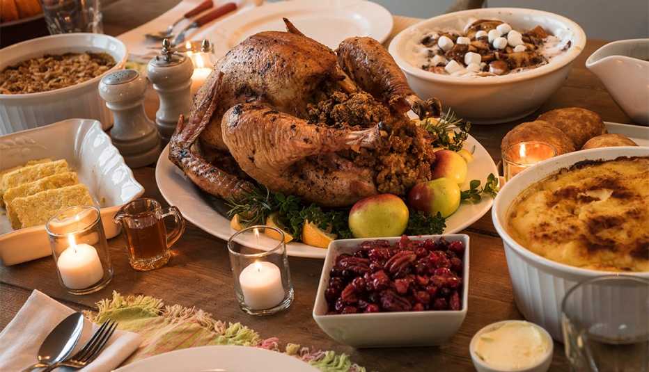 table set for Thanksgiving dinner with turkey, cornbread and more