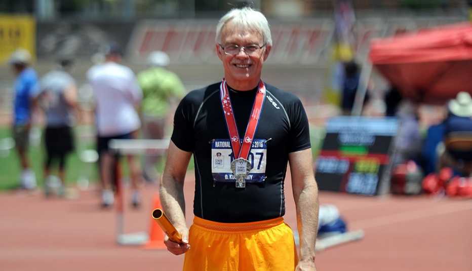 David Kucherawy winning a silver medal in the 4x100 meter relay at the 2019 National Senior Games in Albuquerque, New Mexico