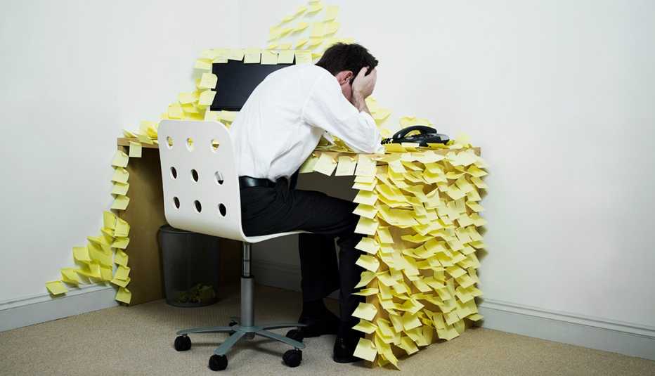 Man at desk with lots of post-it notes