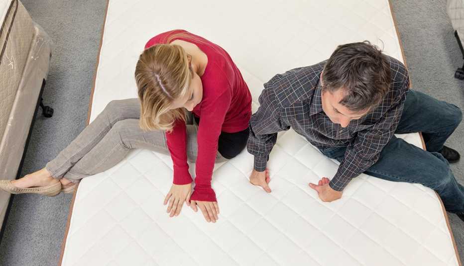 Couple testing out mattresses at a furniture store