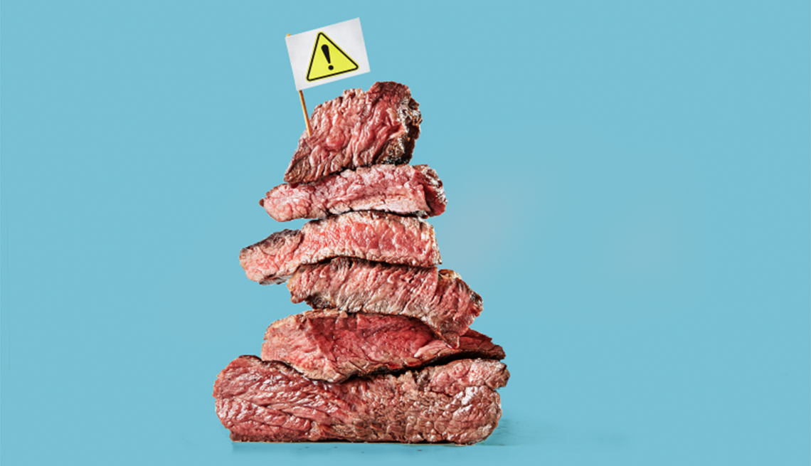 stack of meat with caution sign on top