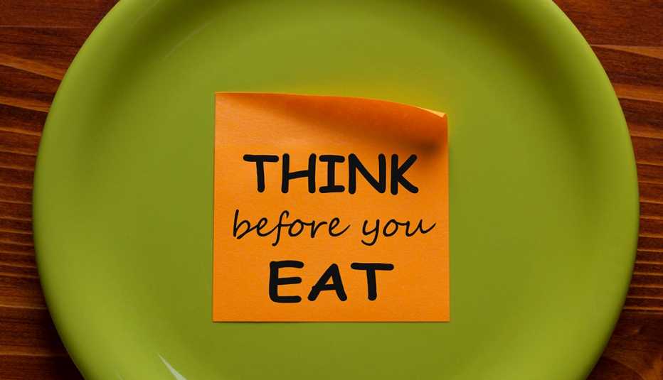Think Before You Eat written on sticky note on a green plate.