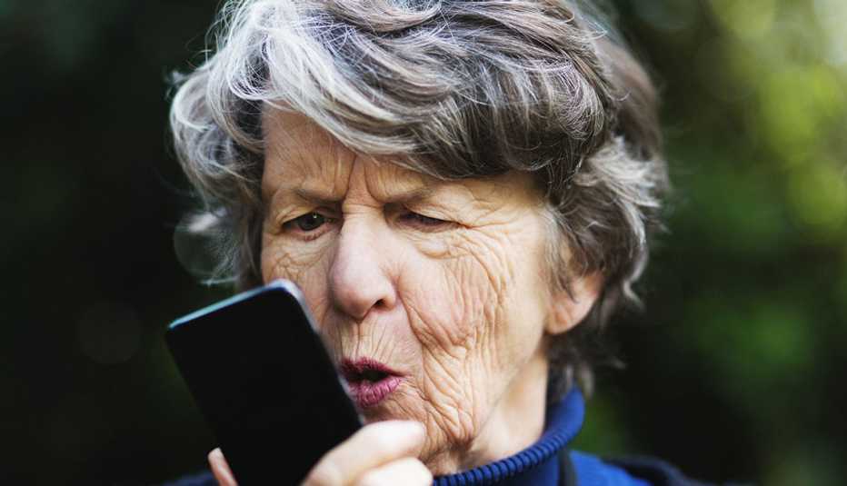 Angry senior woman talking to phone