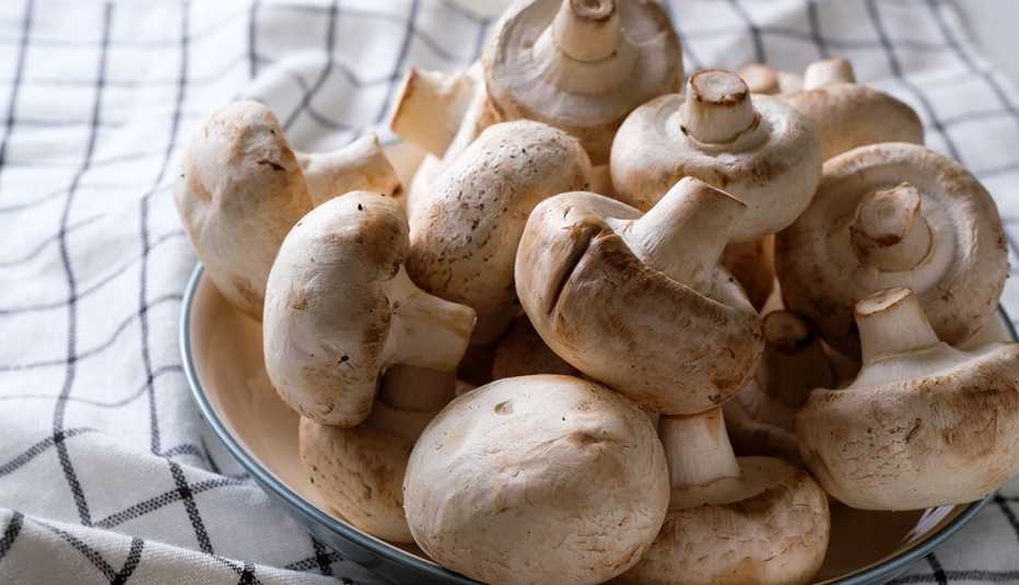 a bowl full of white button mushrooms