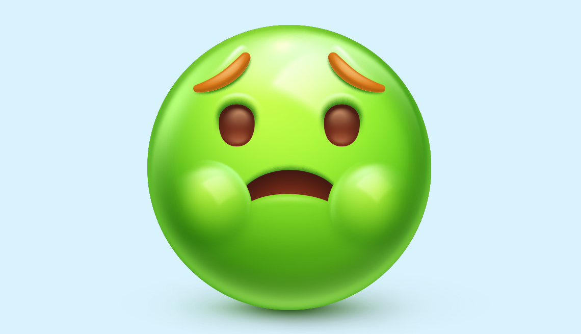 a green faced emoji that looks grossed out