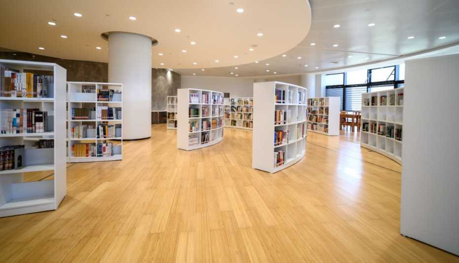 wide shot of an empty library with white book shelves