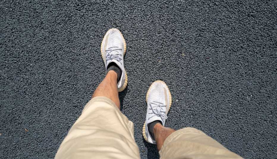 perspective of a man looking down at his feet while walking
