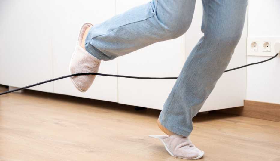 close up of a woman tripping over an extension cord