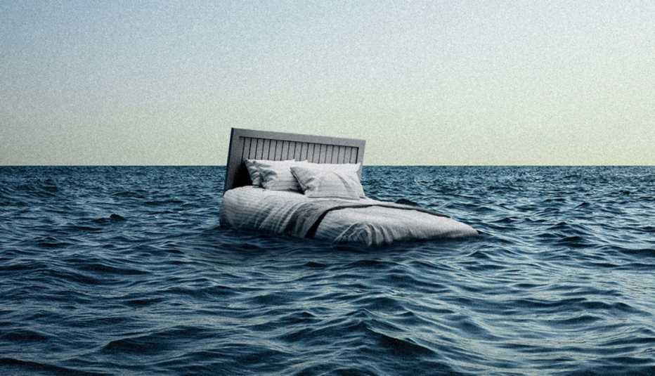 an empty bed drifts in an empty ocean