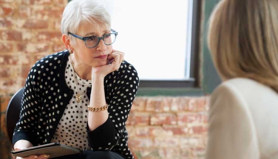 Woman therapist looking at patient and listening