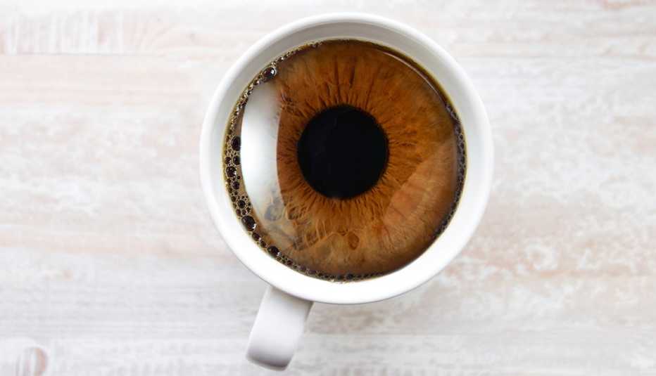 a brown eye iris and pupil in coffee mug from overhead
