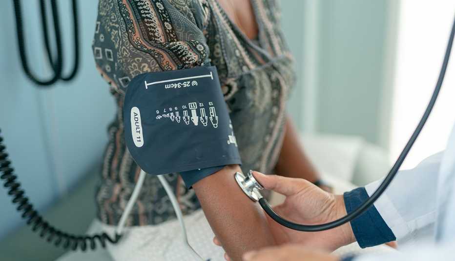woman having her blood pressure checked