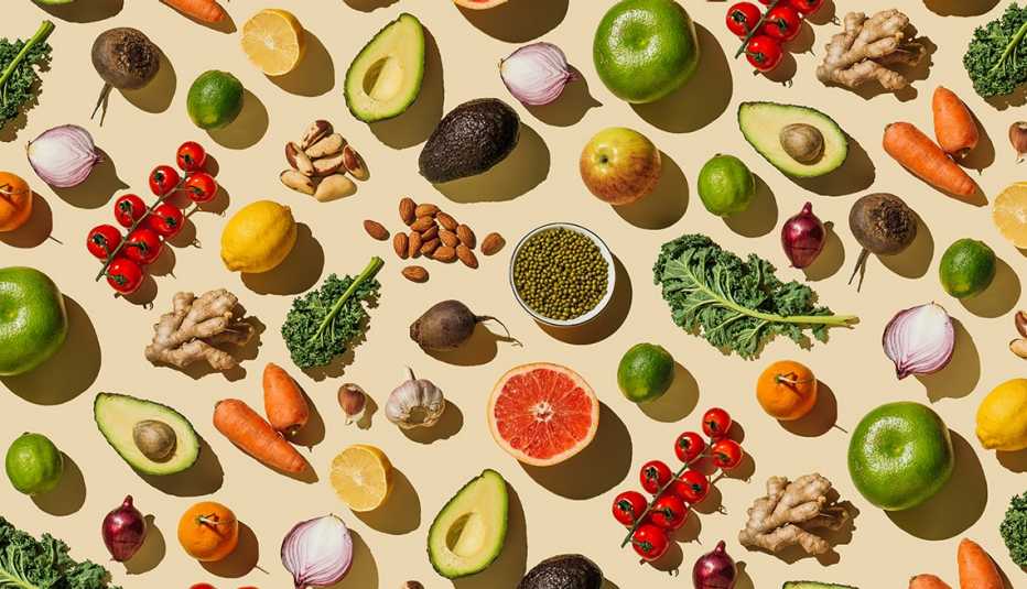 pattern of variety fresh of organic fruits and vegetables and healthy vegan meal ingredients on beige background