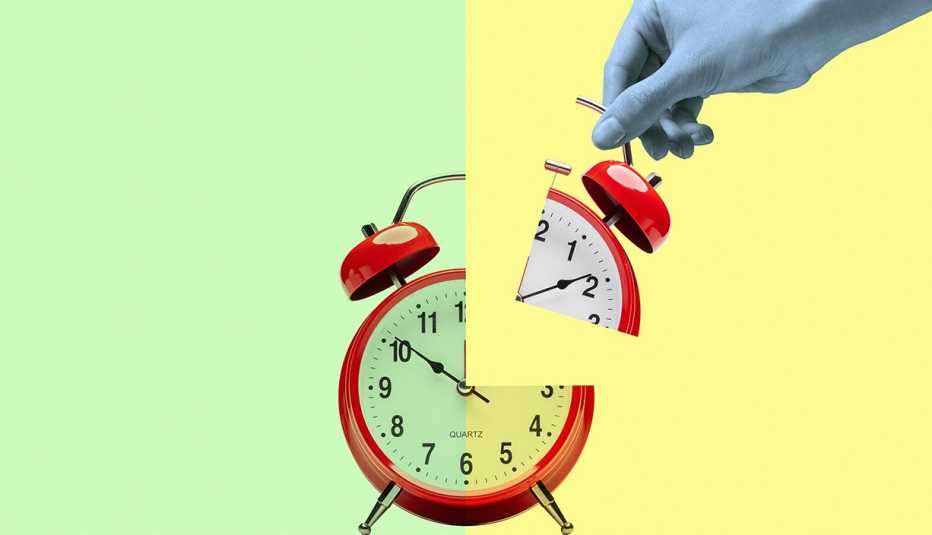 a hand holding a quarter of a red alarm clock on a yellow and green background