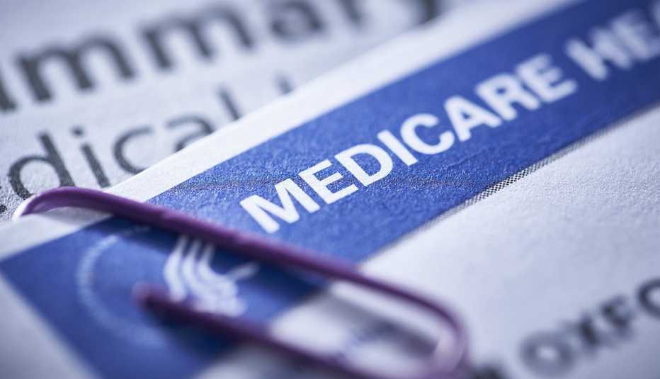 closeup of a Medicare health insurance card with a paperclip
