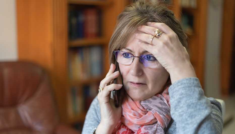woman talking on the phone and looking concerned