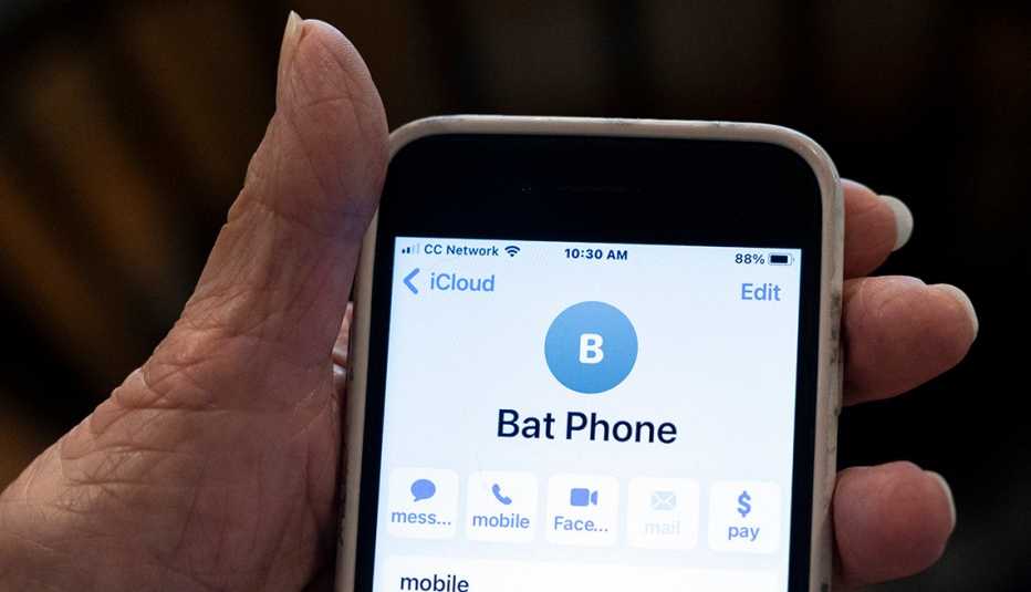 closeup of pat cutillos hand showing us her contact info for her doctors bat phone number