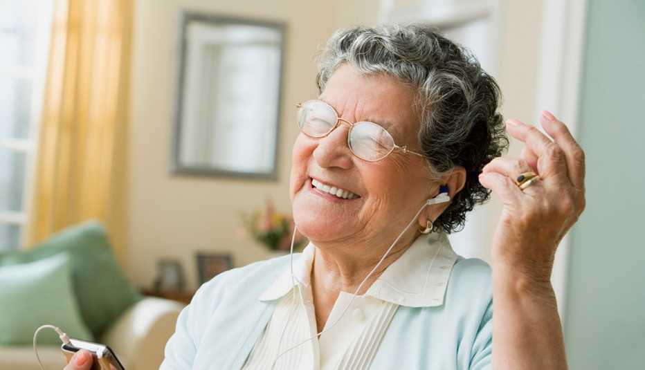 smiling woman listening to music on headphones