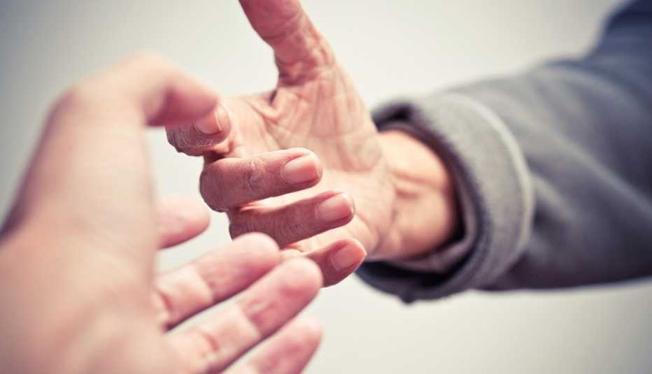 Caregiving for a Sick Friend, two hands reach out