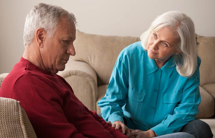 Woman comforting senior man, quiz on symptoms and treatments for depression